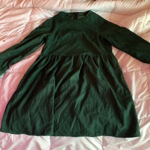 Green dress. Zipper all the way down the back. Button up wrists